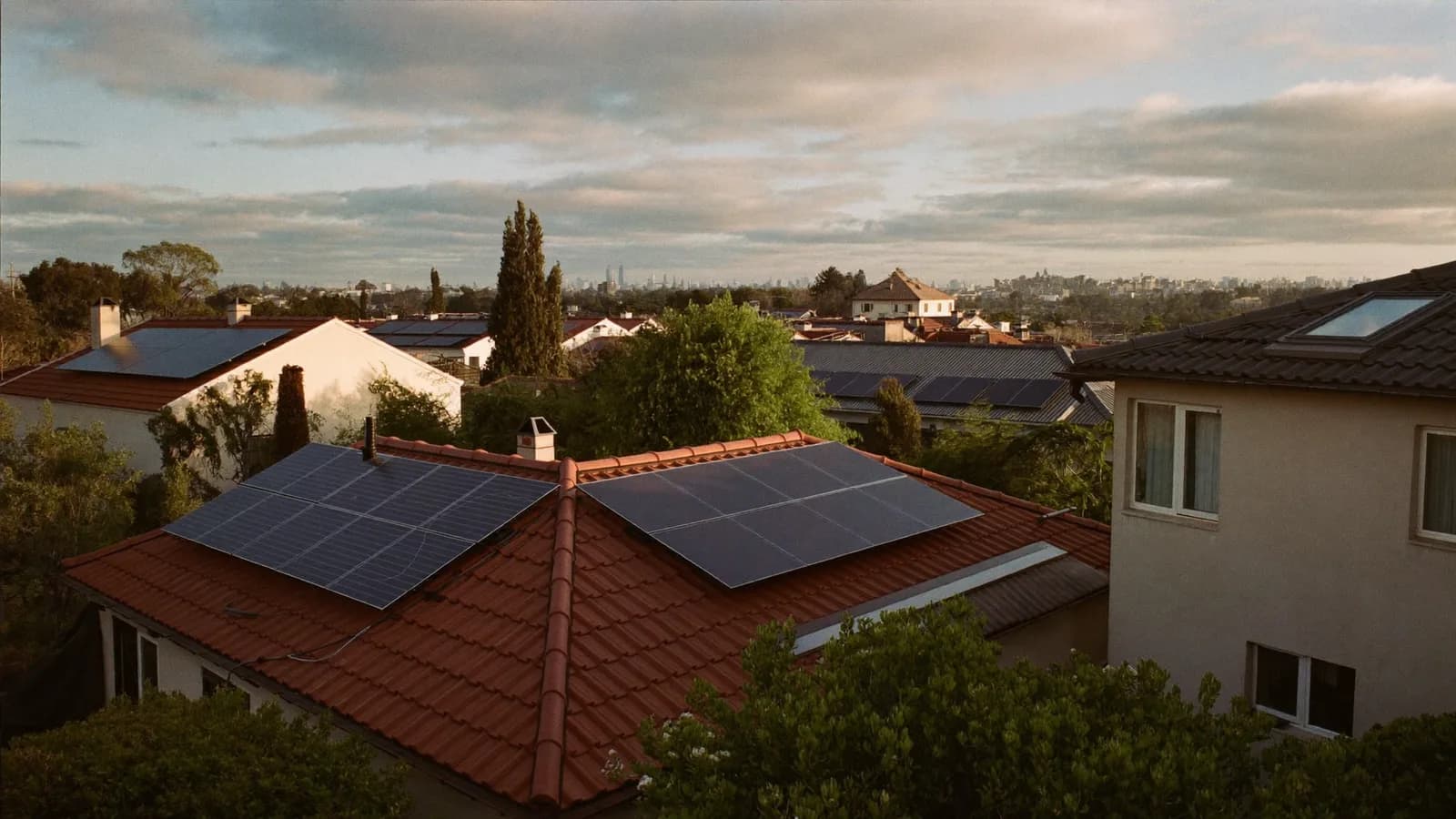 Terracotta rooftops of a Sydney suburb fitted with solar panel arrays
